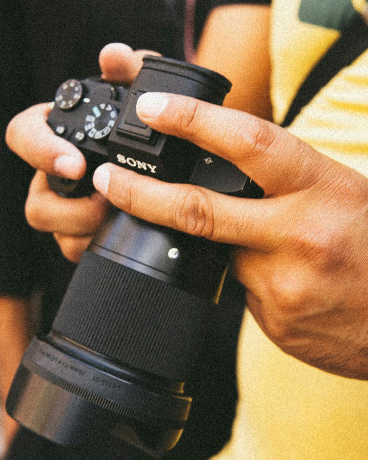 A photographer with their camera in an evocative architectural setting at golden hour