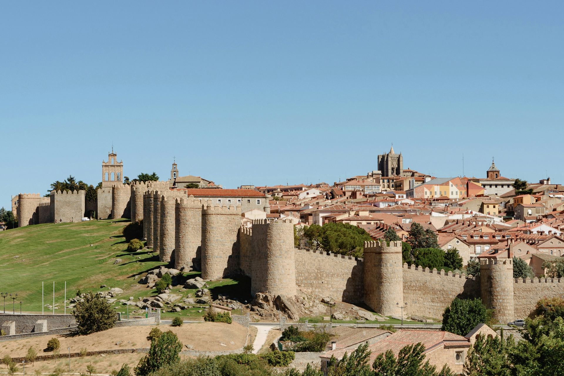 Medieval walls of Ávila under a cobalt sky